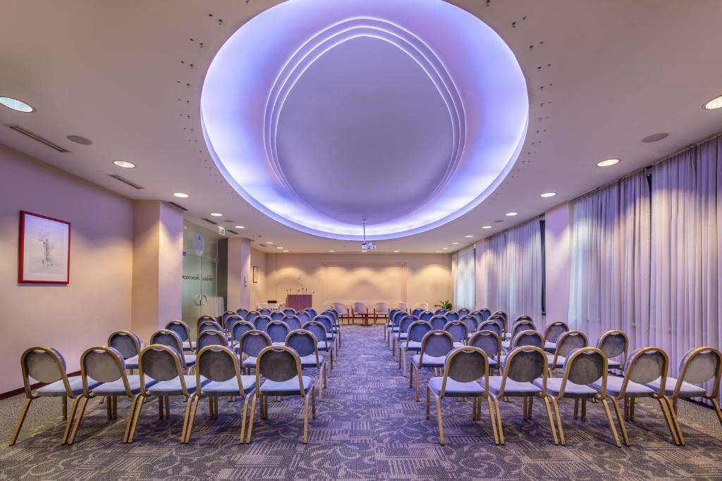 Konferenzraum im Eurostars uHOTEL mit Theaterbestuhlung und indirekter Deckenbeleuchtung.
