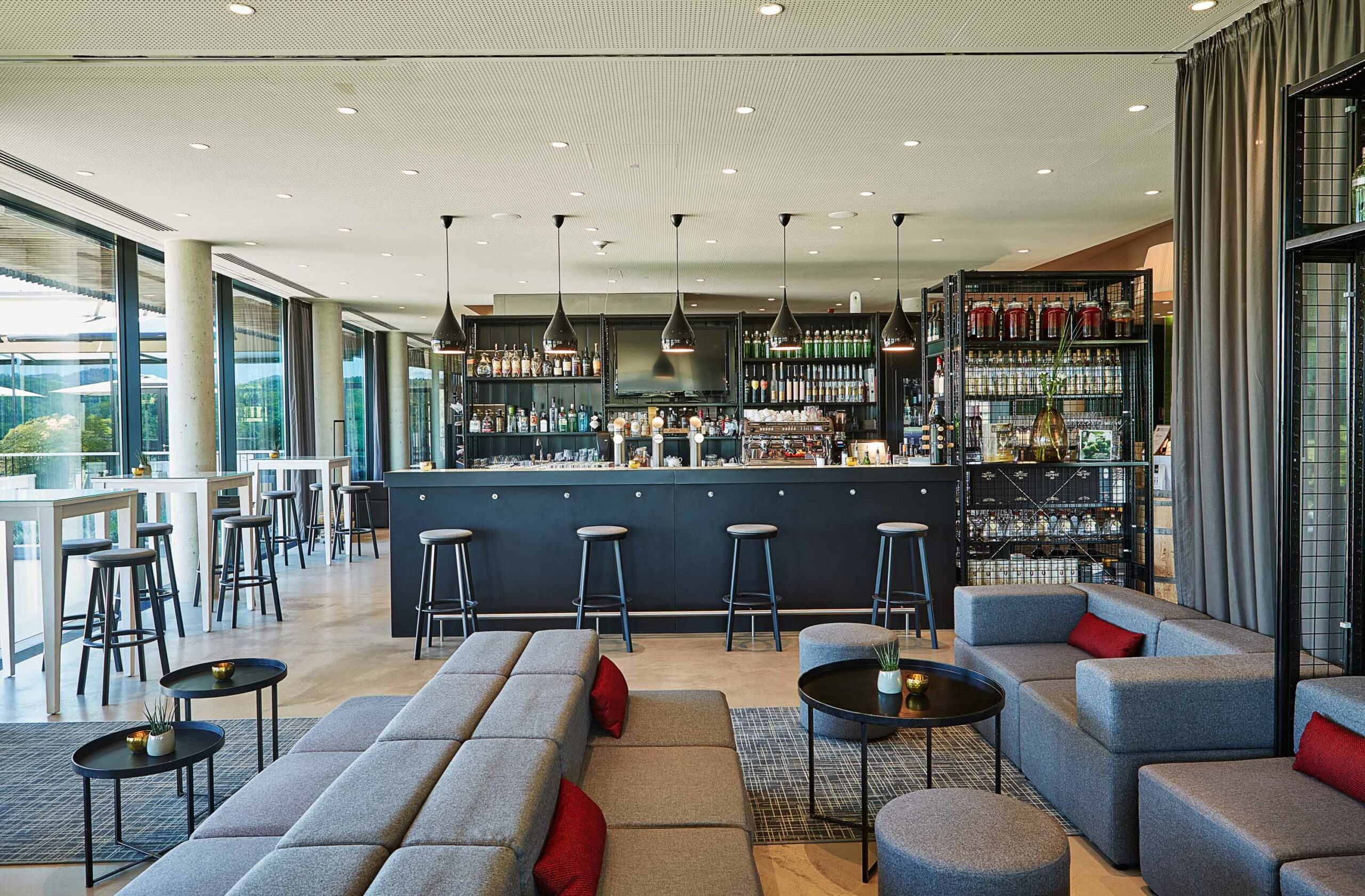 Bar- und Loungebereich im LOISIUM Wine & Spa Hotel Südsteiermark mit Sitzgruppen und moderner Einrichtung.